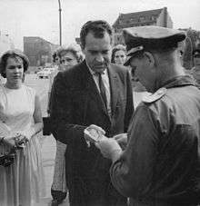 Nixon shows his papers to an East German officer to cross between the 