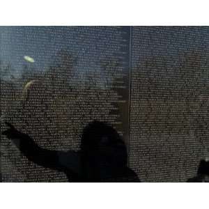  of a Woman Pointing to a Name on the The Vietnam Memorial Travel 