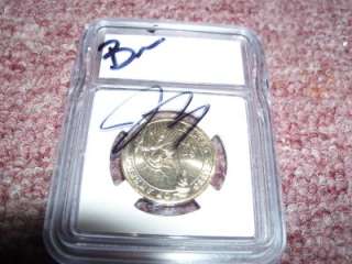 UNCIRCULATED COIN SIGNED BY JARROD AND BRANDI OF STORAGE WARS  