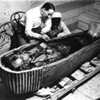 Howard Carter seated beside the coffin of King Tutankhamun 1926 