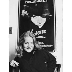 Isabelle Huppert Posing in Front of Movie Poster of Violette Stretched 